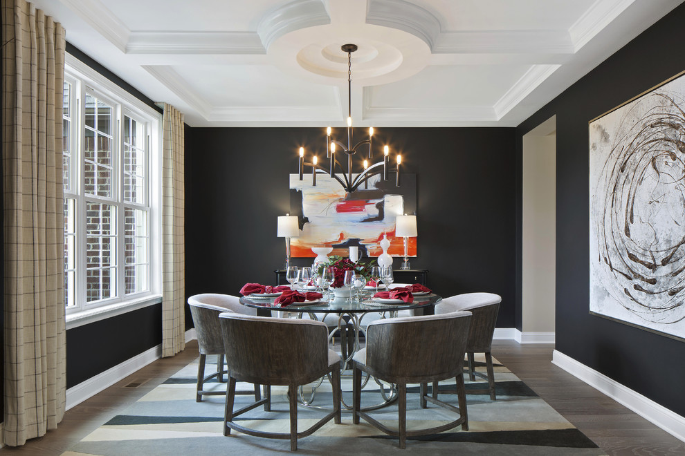 Photo of a transitional dining room in Indianapolis with black walls, dark hardwood floors and brown floor.