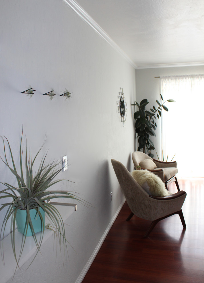 Midcentury enclosed living room in San Francisco with grey walls and dark hardwood floors.