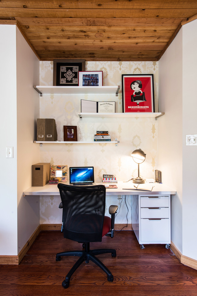 This is an example of a contemporary home office in Chicago with white walls.