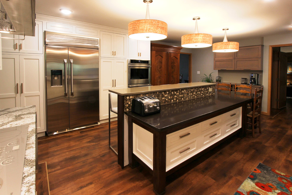 Open concept kitchen - mid-sized transitional l-shaped open concept kitchen idea with a farmhouse sink, beaded inset cabinets, white cabinets, quartzite countertops, white backsplash, stainless steel appliances and an island