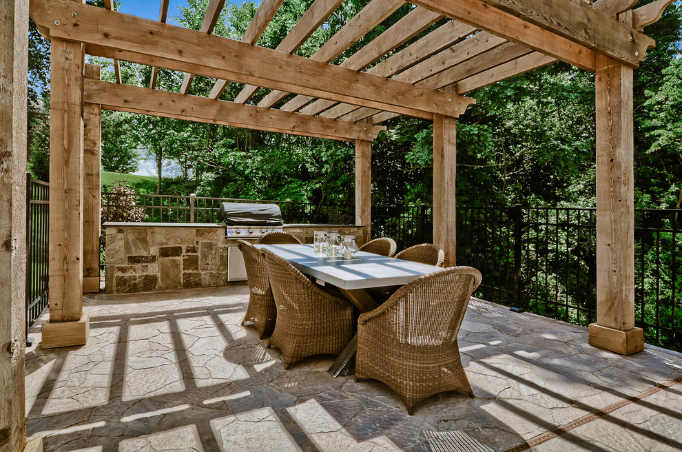 Inspiration for a large arts and crafts side yard patio in Other with an outdoor shower, stamped concrete and a pergola.