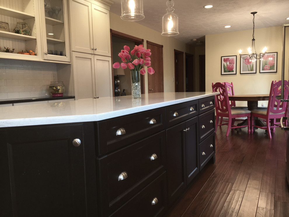 Eat-in kitchen - large transitional medium tone wood floor and brown floor eat-in kitchen idea with an undermount sink, flat-panel cabinets, white cabinets, granite countertops, white backsplash, porcelain backsplash, stainless steel appliances and an island