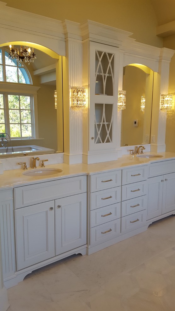 Example of a classic white tile and mosaic tile marble floor alcove shower design in Boston with white cabinets, an undermount tub, a one-piece toilet, gray walls, an undermount sink and marble countertops