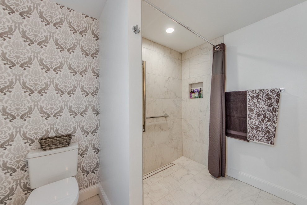 This is an example of a mid-sized contemporary master bathroom in St Louis with a curbless shower, white tile, ceramic tile, ceramic floors, white floor, a shower curtain and wallpaper.