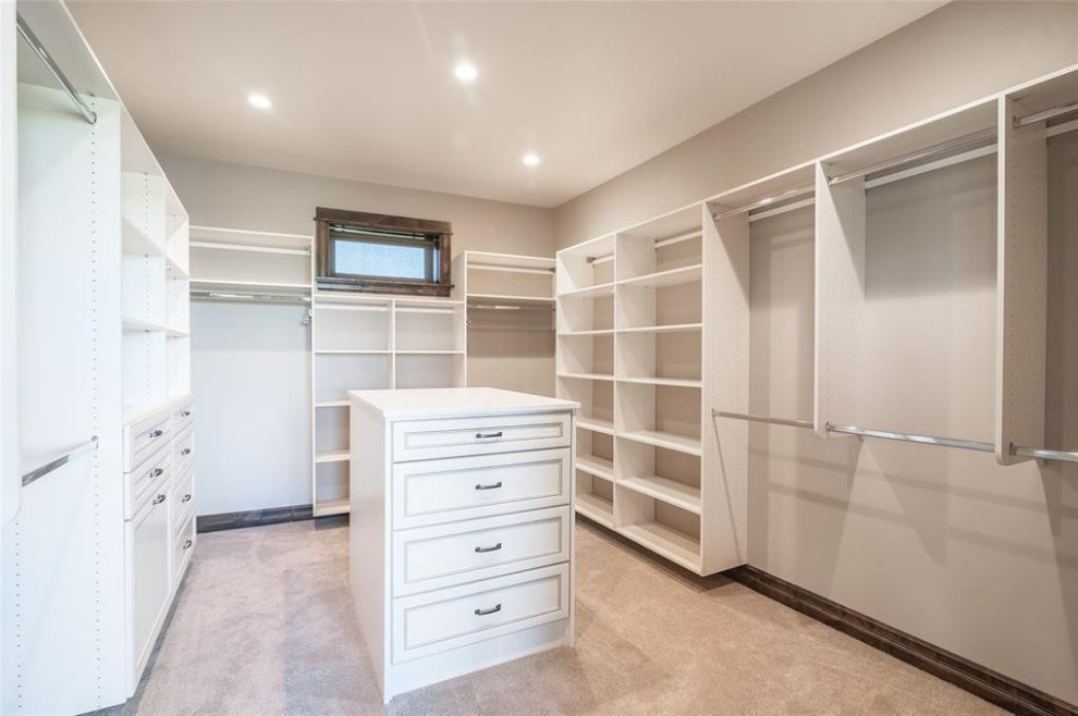 Walk-in closet - large transitional gender-neutral carpeted and beige floor walk-in closet idea with recessed-panel cabinets and white cabinets