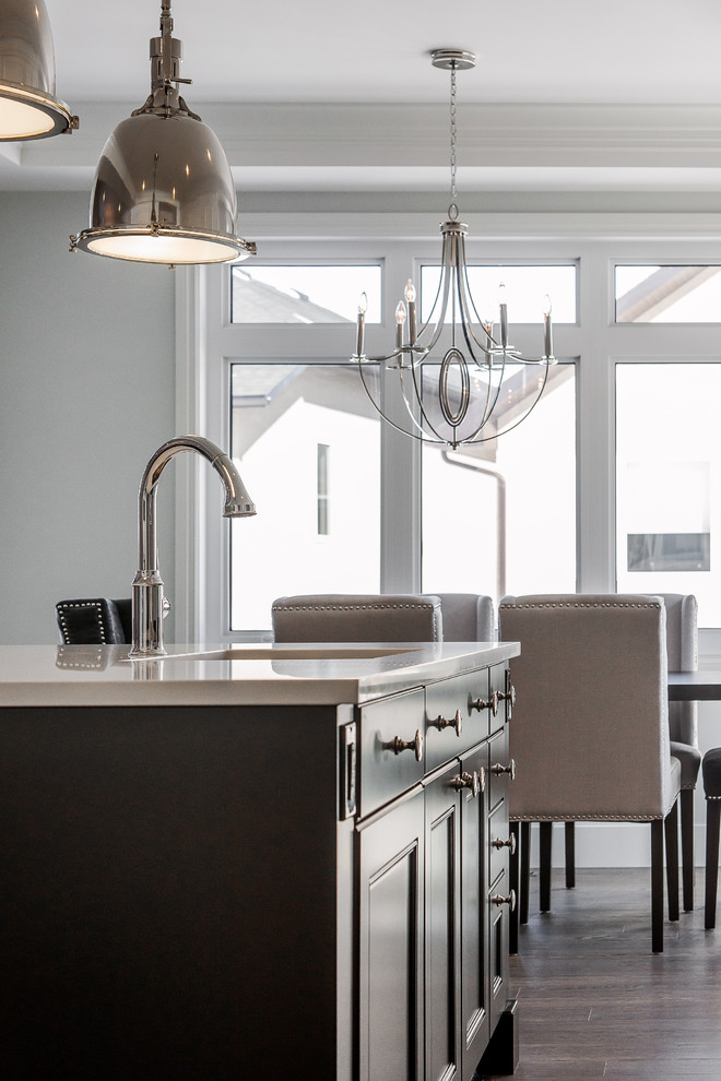Eat-in kitchen - large transitional l-shaped dark wood floor eat-in kitchen idea in Calgary with an undermount sink, dark wood cabinets, quartz countertops, stainless steel appliances and an island