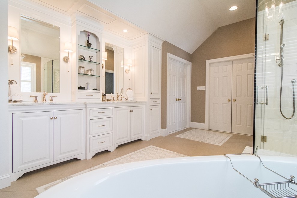 This is an example of a large country master bathroom in Other with beaded inset cabinets, white cabinets, a freestanding tub, a corner shower, beige walls, ceramic floors, a drop-in sink and granite benchtops.