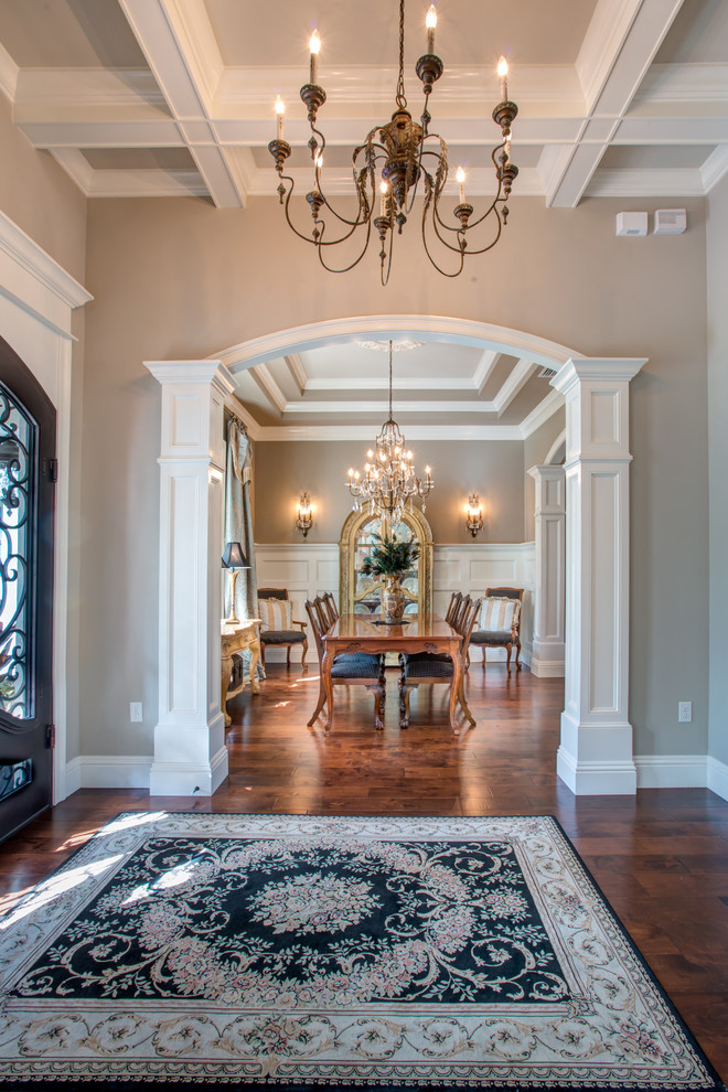 Foyer - large transitional dark wood floor and brown floor foyer idea in Orlando with beige walls and a glass front door