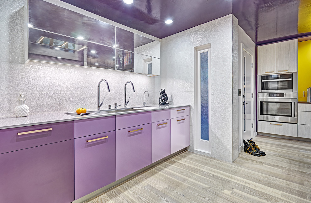 Large modern l-shaped separate kitchen in Sacramento with an undermount sink, flat-panel cabinets, purple cabinets, quartz benchtops, white splashback, porcelain splashback, stainless steel appliances, light hardwood floors and with island.