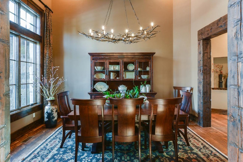 Photo of a country separate dining room in Other with beige walls, medium hardwood floors and brown floor.