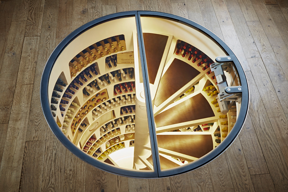 Photo of a mid-sized contemporary wine cellar in New York with concrete floors and storage racks.