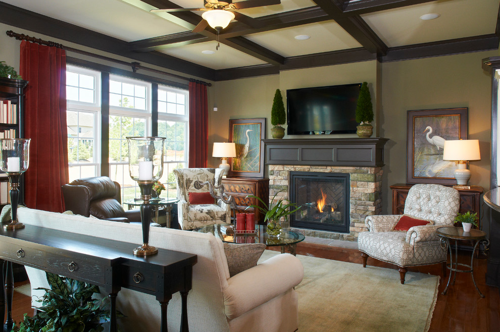 Design ideas for a mid-sized transitional enclosed family room in Other with beige walls, medium hardwood floors, a standard fireplace, a stone fireplace surround and a wall-mounted tv.