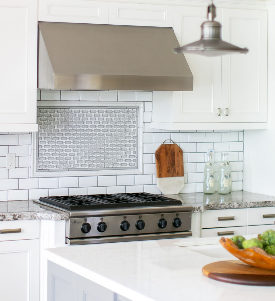 Kitchen - large transitional medium tone wood floor and brown floor kitchen idea in Orange County with an undermount sink, shaker cabinets, gray cabinets, quartz countertops, white backsplash, subway tile backsplash, stainless steel appliances, an island and white countertops