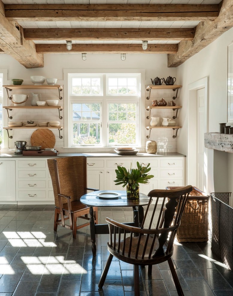 Country single-wall eat-in kitchen in Boston with shaker cabinets, white cabinets, white splashback, subway tile splashback, cement tiles, grey floor and grey benchtop.