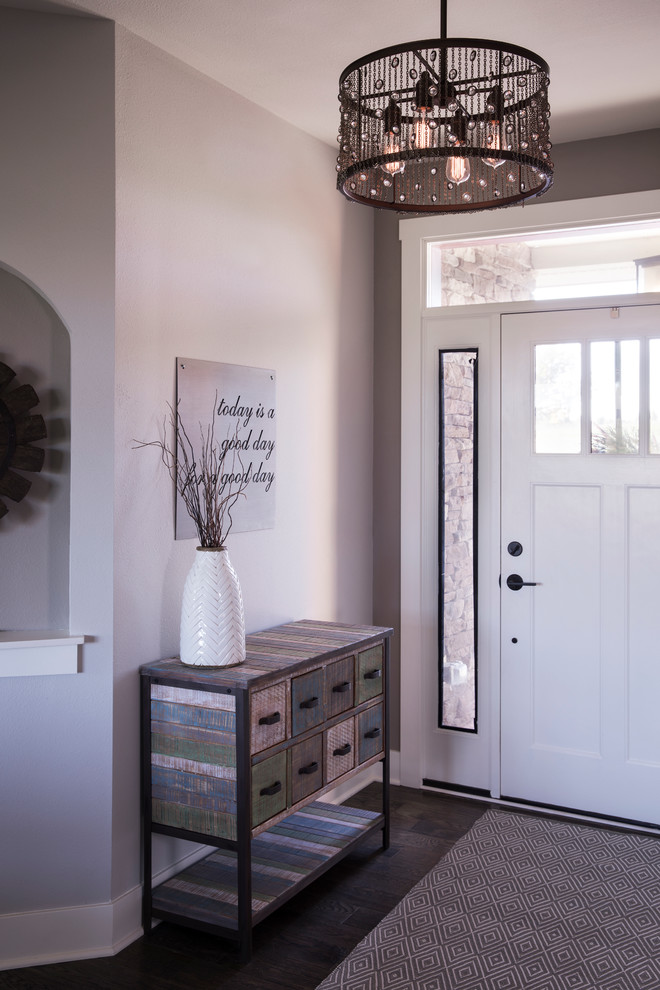 Example of a mid-sized transitional dark wood floor foyer design in Milwaukee with gray walls and a white front door
