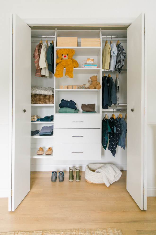Inspiration for a small classic standard wardrobe in Other with flat-panel cabinets, white cabinets and light hardwood flooring.