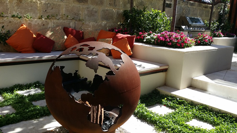 Inspiration for a contemporary courtyard patio in Perth with a fire feature and natural stone pavers.