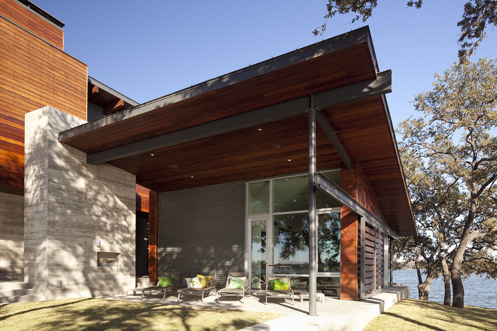 Photo of a large contemporary two-storey multi-coloured exterior in Austin with metal siding and a flat roof.