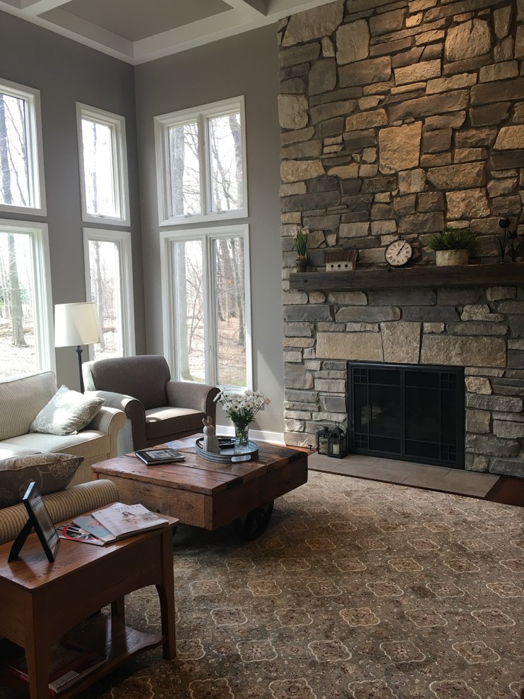 Design ideas for an arts and crafts living room in Grand Rapids with a stone fireplace surround.
