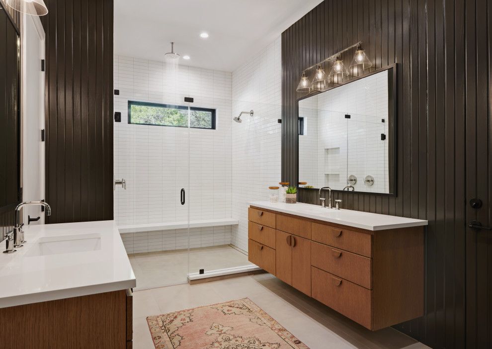 Inspiration for a mid-sized contemporary master bathroom in Austin with flat-panel cabinets, light wood cabinets, a double shower, white tile, subway tile, black walls, porcelain floors, an undermount sink, quartzite benchtops, grey floor, a hinged shower door and white benchtops.