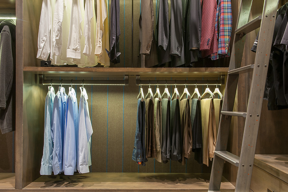 This is an example of an expansive country men's walk-in wardrobe in Phoenix with flat-panel cabinets, distressed cabinets, porcelain floors and multi-coloured floor.