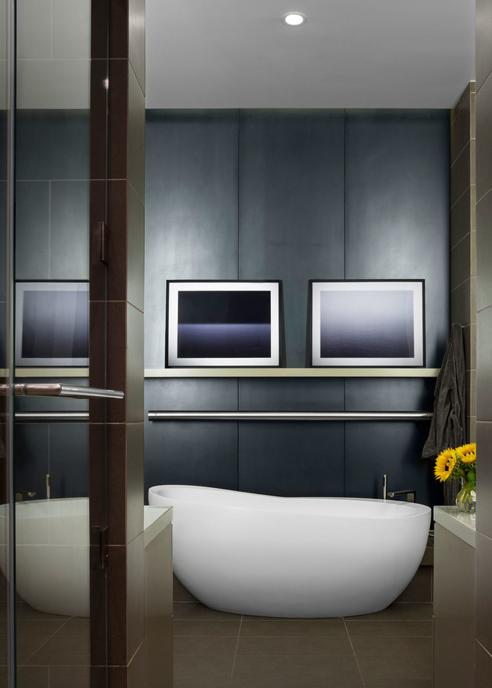 Trendy ceramic tile freestanding bathtub photo in Chicago with gray walls