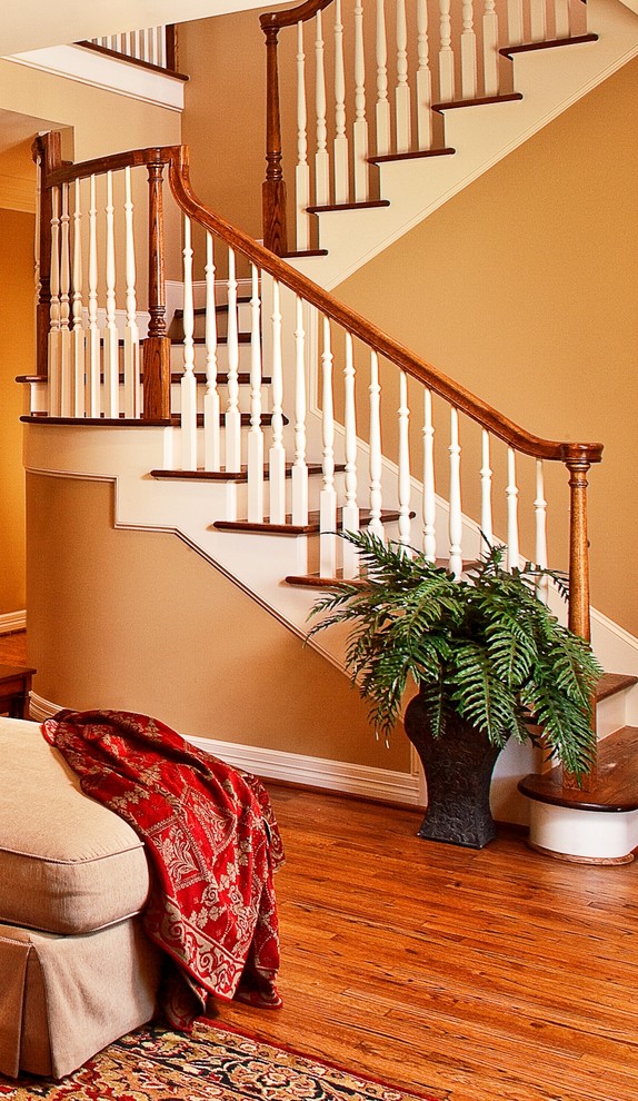 Inspiration for a mid-sized traditional wood u-shaped staircase in Houston with wood risers.