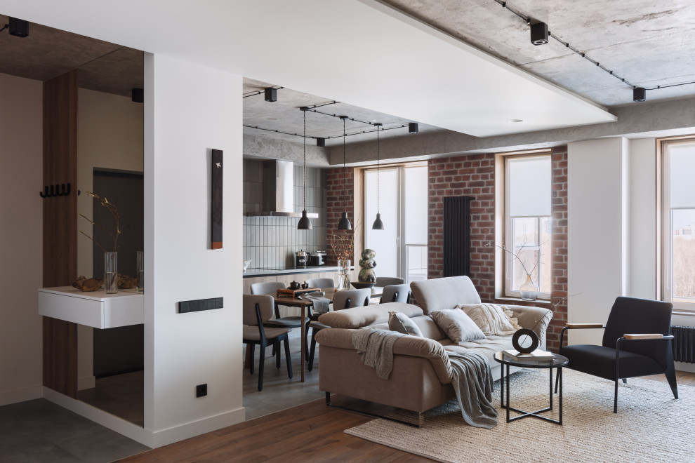 Esempio di un soggiorno industriale di medie dimensioni con pareti bianche, pavimento in laminato, pavimento marrone, soffitto ribassato e pareti in mattoni