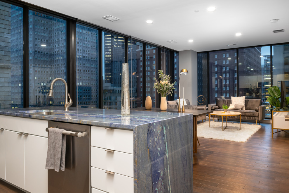 This is an example of a modern kitchen in Other with a submerged sink, flat-panel cabinets, quartz worktops, blue splashback, an island and blue worktops.