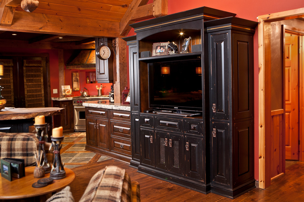 Example of a mid-sized mountain style u-shaped medium tone wood floor eat-in kitchen design in Toronto with raised-panel cabinets, distressed cabinets, granite countertops, paneled appliances and an island