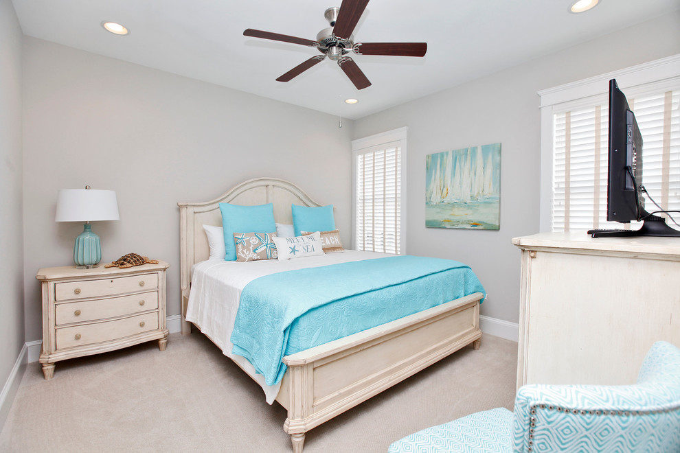 Mid-sized beach style guest bedroom in San Diego with carpet, beige floor and grey walls.