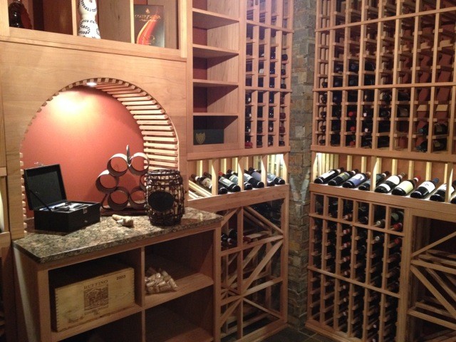 Mid-sized contemporary wine cellar in Toronto with slate floors, storage racks and grey floor.