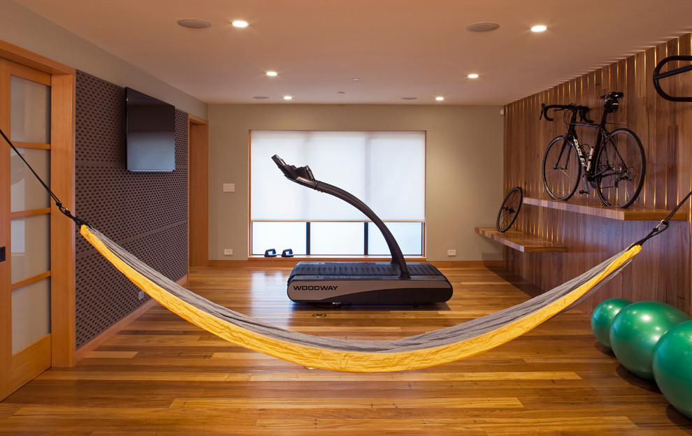 Photo of a mid-sized contemporary multipurpose gym in San Francisco with brown walls, medium hardwood floors and brown floor.