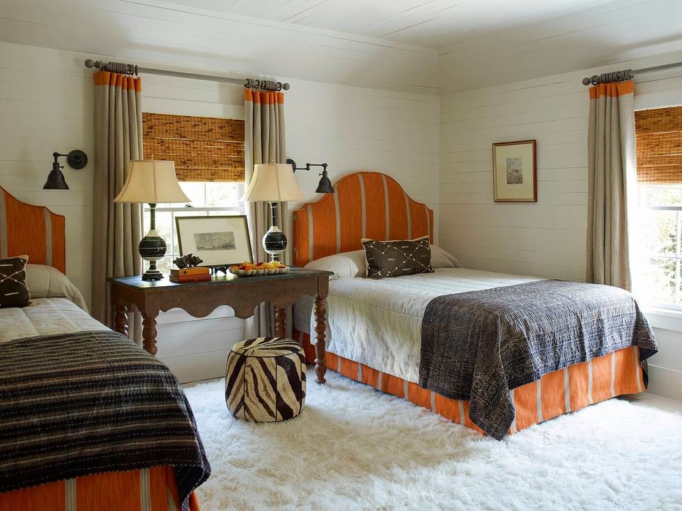 Mid-sized beach style guest bedroom in Charleston with white walls.