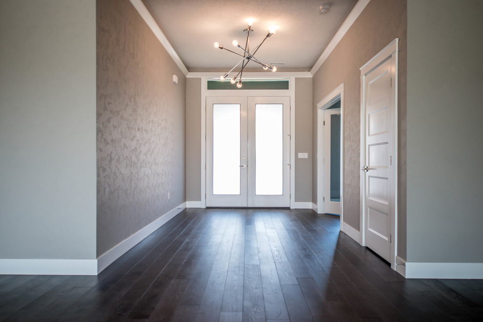 Inspiration for a mid-sized transitional dark wood floor entry hall remodel in Seattle with gray walls and a white front door