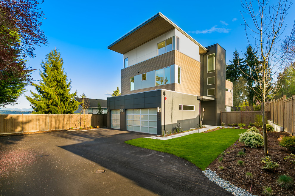 Large modern three-storey black house exterior in Seattle with mixed siding and a flat roof.