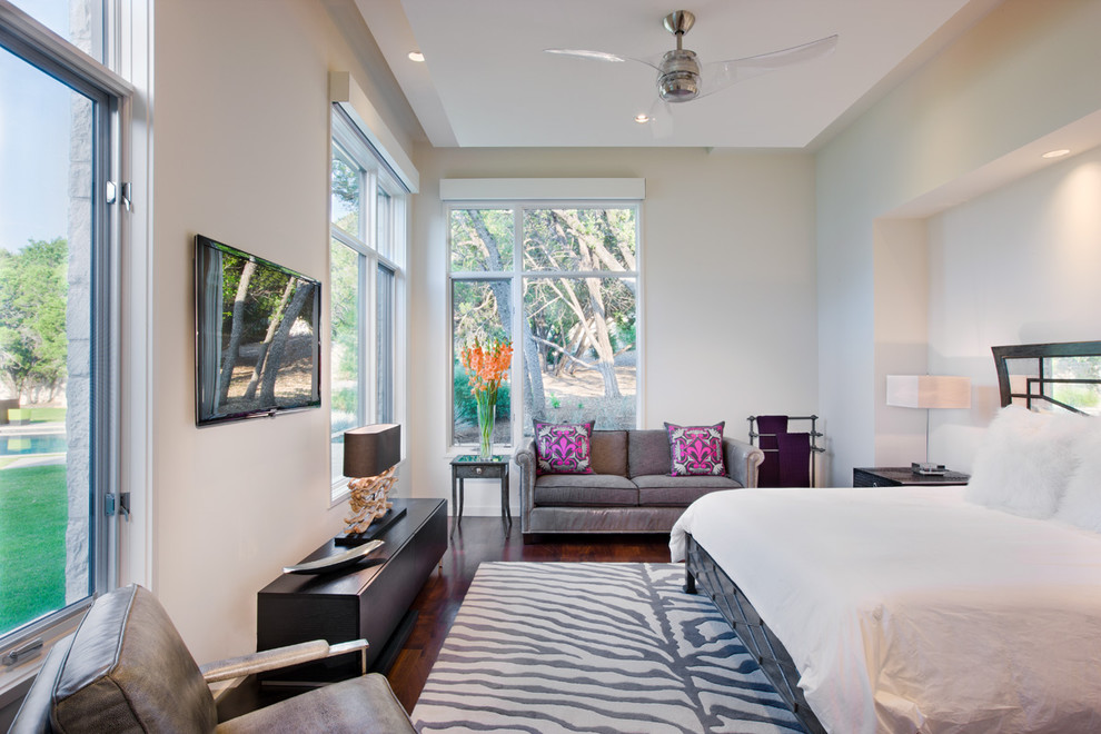 Contemporary master bedroom in Austin with white walls and dark hardwood floors.