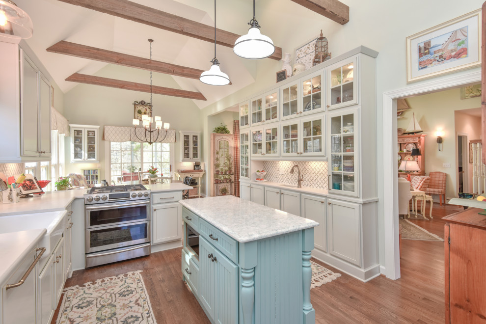 Example of a large transitional u-shaped kitchen design in DC Metro with a farmhouse sink, recessed-panel cabinets, quartz countertops, stainless steel appliances and an island