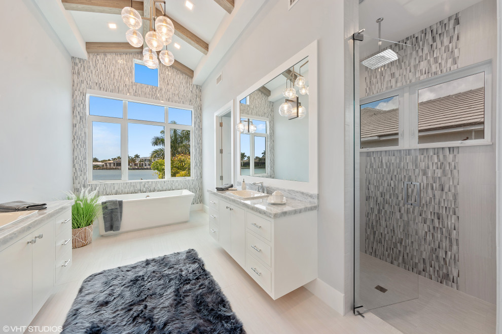 Photo of a mid-sized beach style master bathroom in Tampa with open cabinets, white cabinets, a freestanding tub, a double shower, an urinal, multi-coloured tile, glass tile, blue walls, porcelain floors, a drop-in sink, onyx benchtops, white floor, a hinged shower door and blue benchtops.