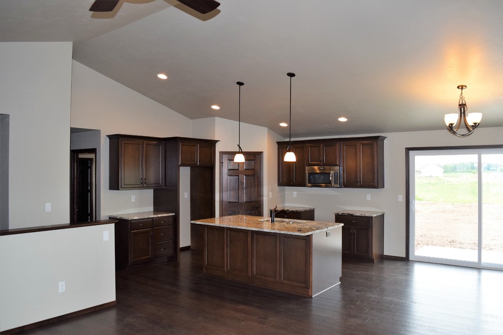 Kitchen - rustic kitchen idea with white cabinets, stainless steel appliances and an island
