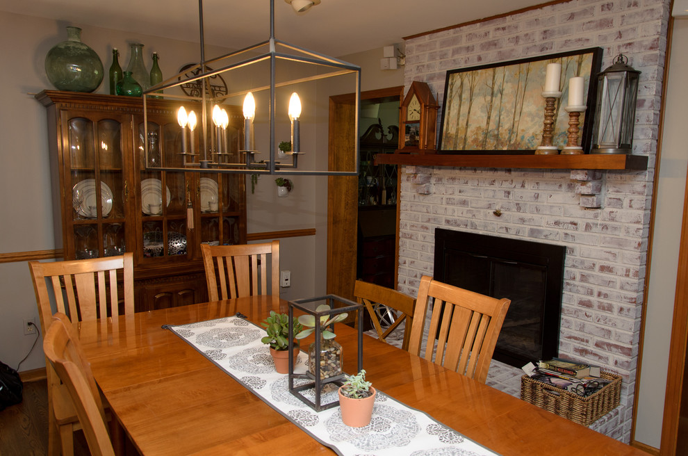 Transitional medium tone wood floor kitchen/dining room combo photo in Cincinnati with gray walls, a standard fireplace and a brick fireplace