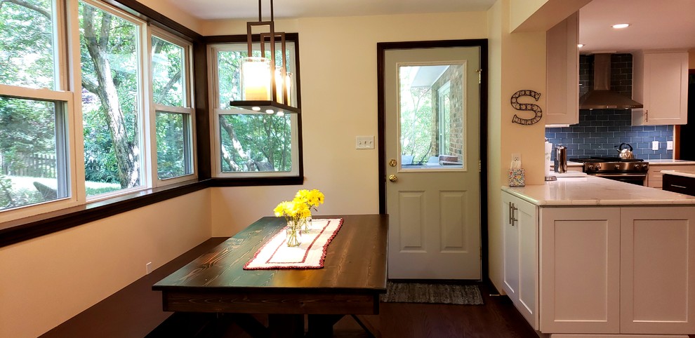 Eat-in kitchen - large transitional u-shaped medium tone wood floor eat-in kitchen idea with shaker cabinets, white cabinets, quartzite countertops, blue backsplash, glass tile backsplash, stainless steel appliances, an island and white countertops