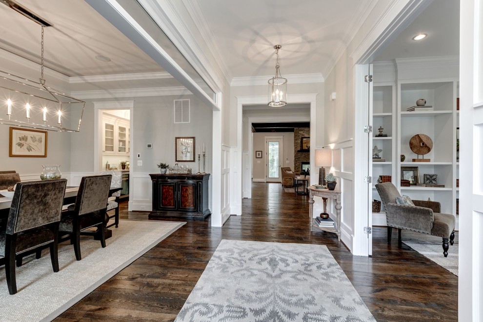 This is an example of a mid-sized country entry hall in DC Metro with beige walls, dark hardwood floors, a single front door and a dark wood front door.