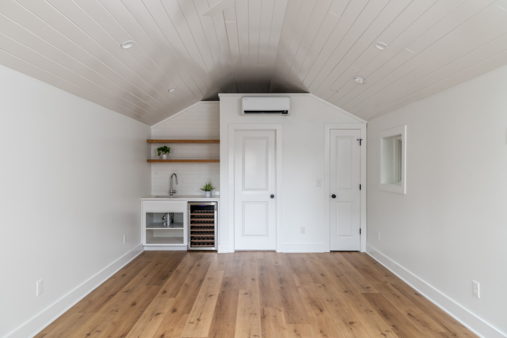Photo of a mid-sized transitional home studio in Atlanta with white walls, vinyl floors, no fireplace, beige floor, timber and planked wall panelling.