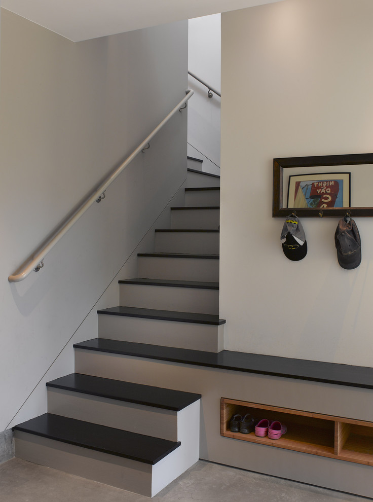 This is an example of a mid-sized contemporary wood l-shaped staircase in San Francisco with painted wood risers.