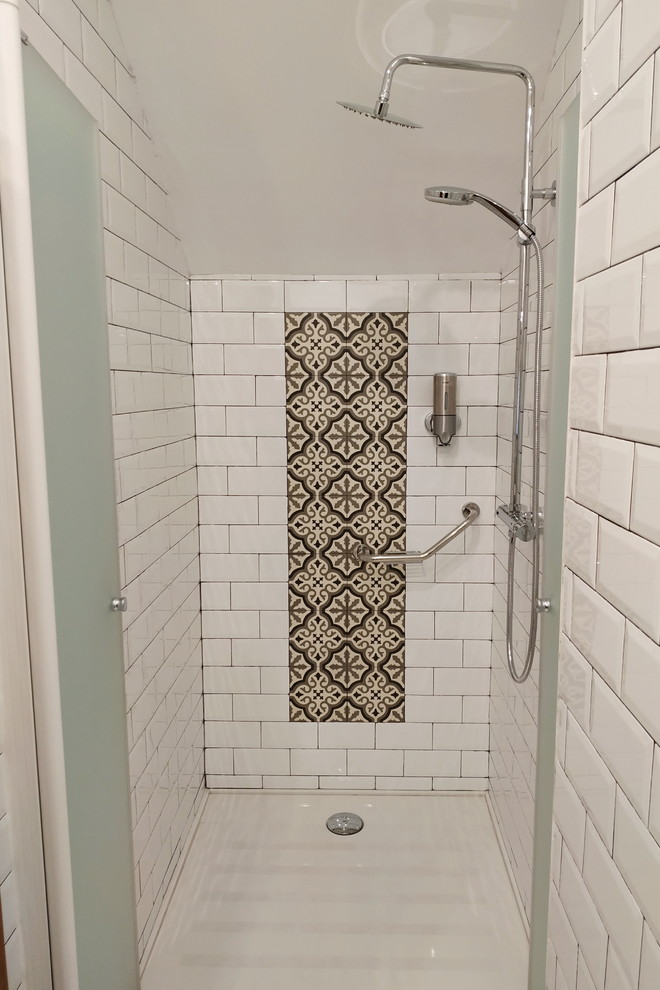 Inspiration for a small 3/4 wet room bathroom in Other with open cabinets, black cabinets, an urinal, white tile, subway tile, white walls, a vessel sink, granite benchtops, a hinged shower door, black benchtops, marble floors and white floor.