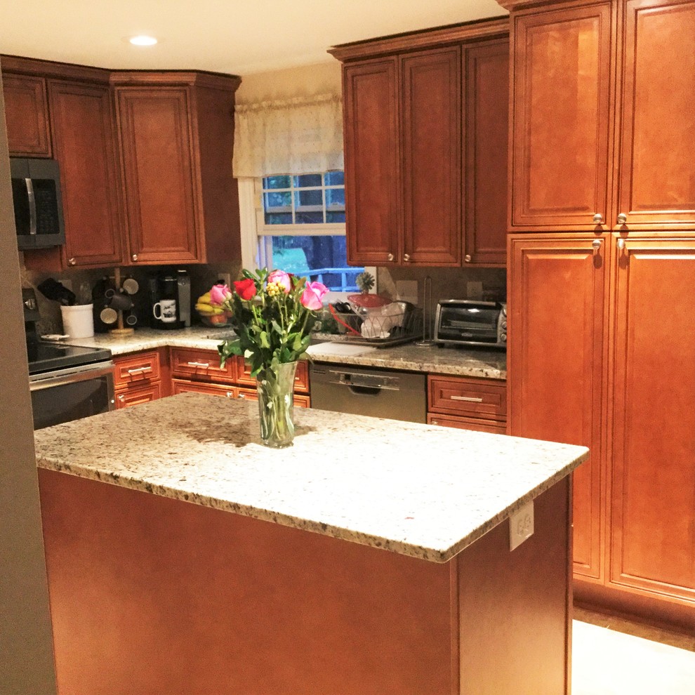 Large transitional l-shaped porcelain tile eat-in kitchen photo in DC Metro with an undermount sink, raised-panel cabinets, medium tone wood cabinets, granite countertops, beige backsplash, porcelain backsplash, stainless steel appliances and an island