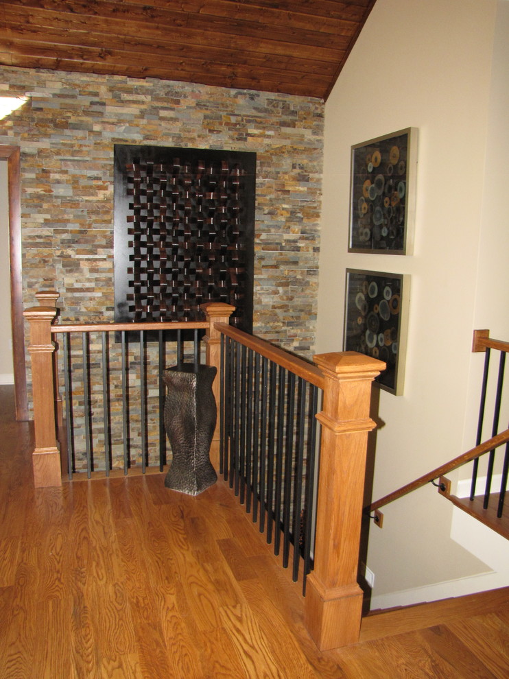 Large traditional wood l-shaped staircase in Other with wood risers and mixed railing.