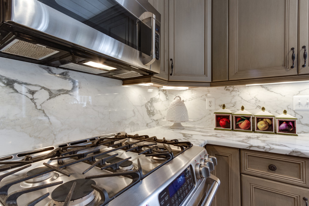 This is an example of a large traditional u-shaped eat-in kitchen in DC Metro with an undermount sink, shaker cabinets, green cabinets, marble benchtops, ceramic splashback and panelled appliances.