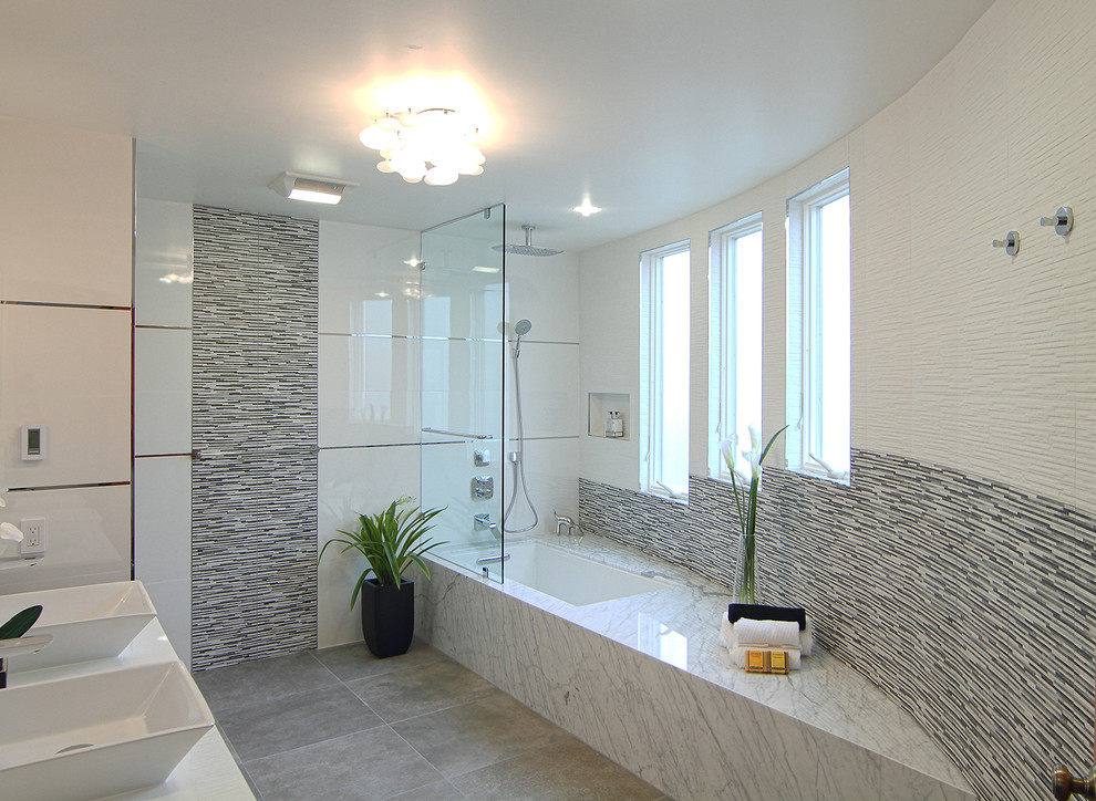 Design ideas for a contemporary bathroom in San Francisco with a vessel sink, a drop-in tub, an open shower, a two-piece toilet, flat-panel cabinets, black cabinets, engineered quartz benchtops, white tile and glass tile.